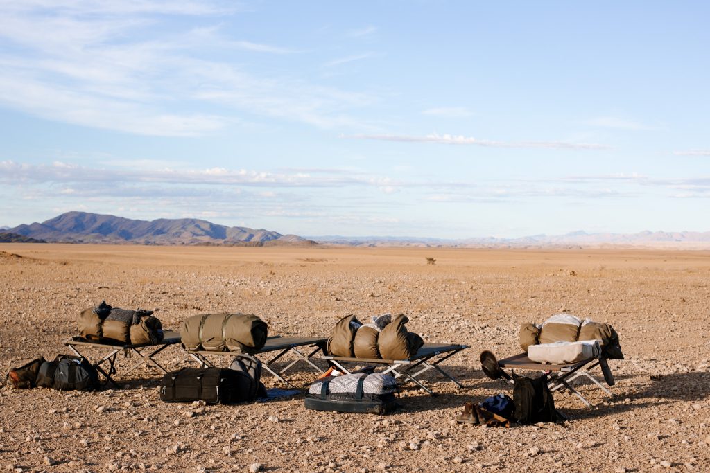 small and light bags packed by sustainable travellers are laid out on the floor