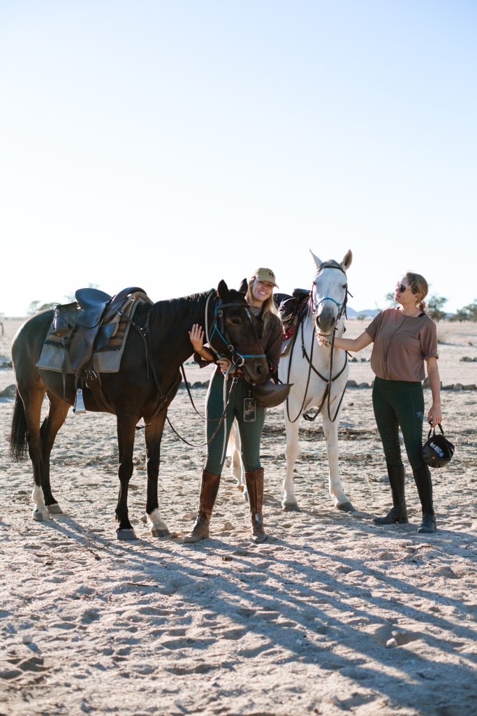 Male and female Travellers and horses packed up ready to go on Safari 