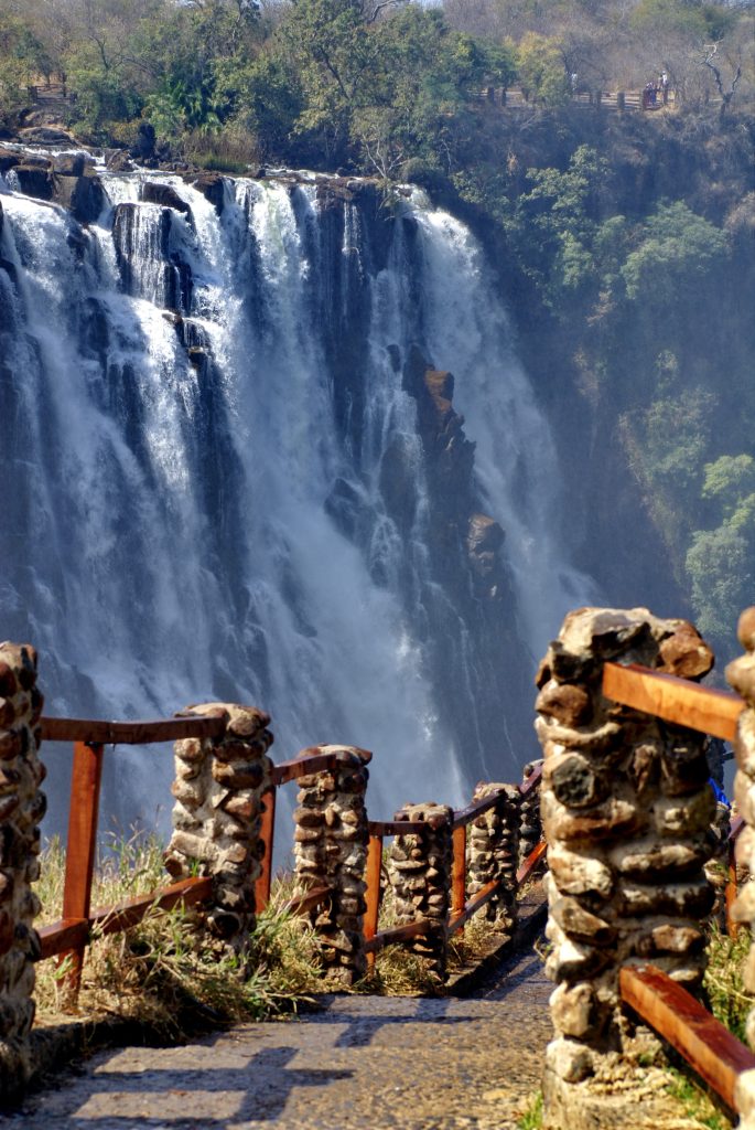 Victoria Falls in the dry season, seen from Zambia, with a trail running along the edge of the gorge
