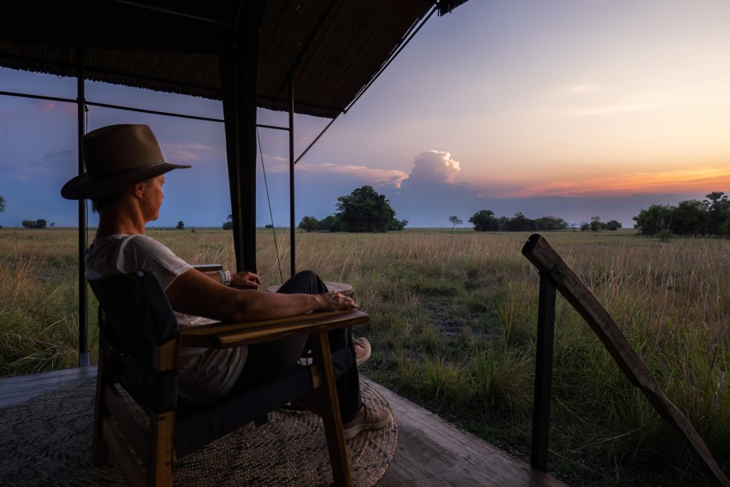 Traveller on horseback safari at rest stop and looking at the sunset whilst at rest stop 